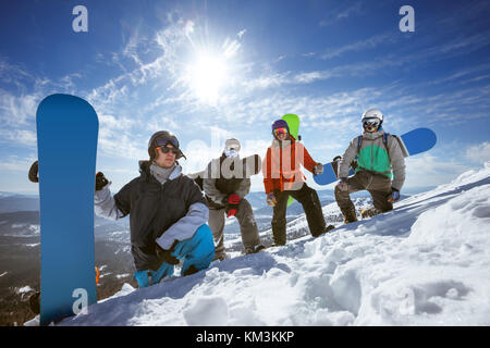 Four snowboarders at ski slope Stock Photo