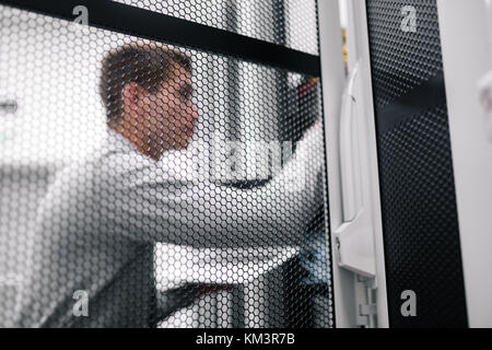 Man fix server network in data center room . Stock Photo