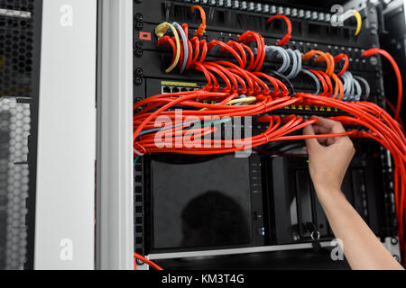 Close-up Of Engineers hand checking Server In Data Center Stock Photo
