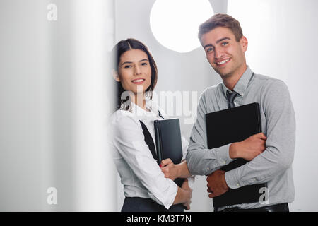 Team of technicians working together on servers at the data centre Stock Photo