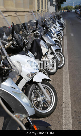 Firenze, FI, Italy - August 21, 2015: many mopeds scooters and motorcycles parked along the busy street Stock Photo