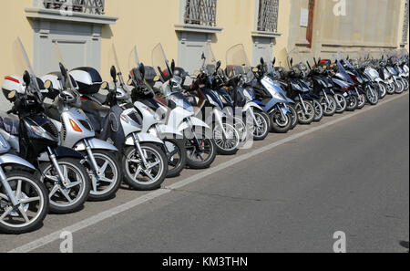 Firenze, FI, Italy - August 21, 2015: many mopeds scooters and motorcycles parked along the busy street Stock Photo