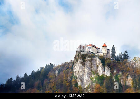 Medieval Bled castle on cliff overlooking Bled lake in Slovenia, autumn season. Copy space