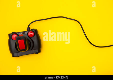 Retro computer gaming controller on a bright yellow background Stock Photo