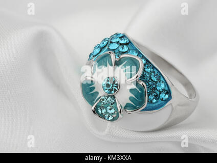 Jewelery ring on white cloth background Stock Photo