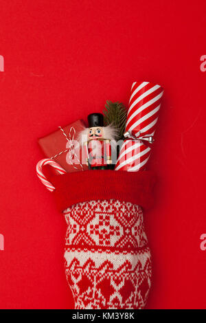 Christmas stocking with cracker, toy and wrapped present Stock Photo