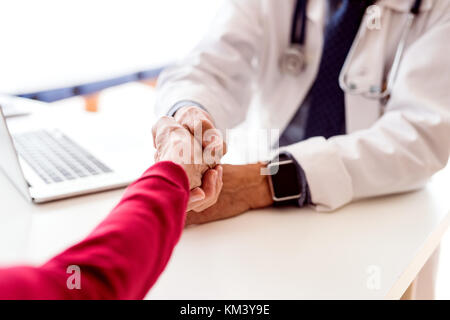 Doctor with laptop and a senior woman in office. Stock Photo