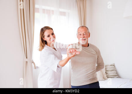 Health visitor and senior man during home visit. Stock Photo