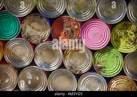 Colorful Cans stacked along the wall of a cemetery in Mexico Stock Photo