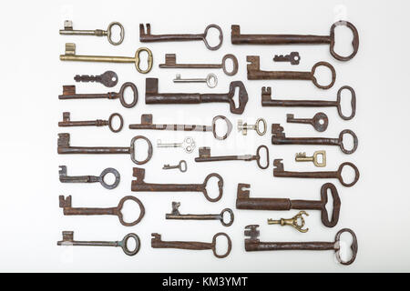 Different size old rusty keys  isolated on white background Stock Photo
