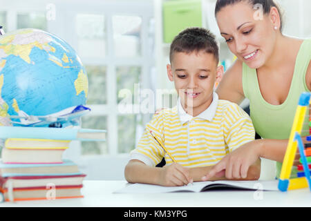 mother and son doing homework Stock Photo
