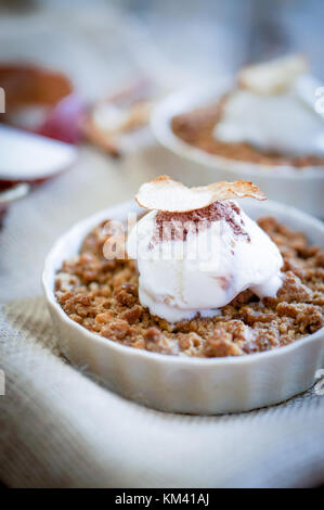 Apple Crumble Dessert With Cinnamon And Vanilla Ice Cream On Wooden Background Stock Photo