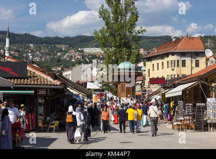 SARAJEVO, BOSNIA HERZEGOVINA - AUGUST 18 2017: Day view of Bascarsija square with its fountain and a crowd of people in Sarajevo, summer season Stock Photo