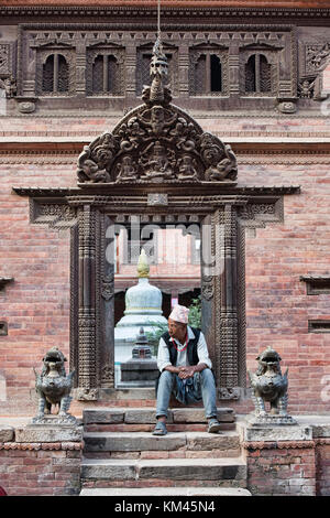 Sitting on the temple steps, Bhaktapur, Nepal Stock Photo