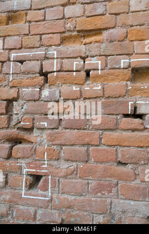 Machine gun bullet holes in brick wall at Jallianwala Bagh, Amritsar, where the British Army opened fire and massacred a crowd of unarmed protestors Stock Photo