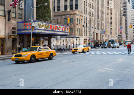New York City, USA - Nov 12, 2011 : Yellow taxis and traffic in front of the Radio City Music Hall Stock Photo