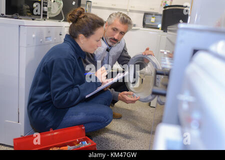 couple choosing new clothes washing machine in supermarket Stock Photo