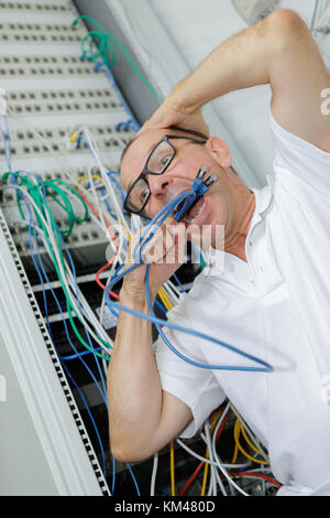 confused it professional with cables in a data center Stock Photo
