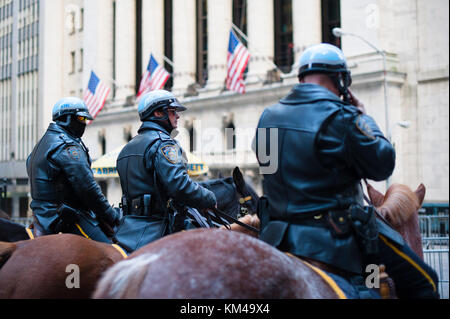 New York City, USA - Nov 12, 2011 : Three policemen on horses in front of the New York Stock Exchange building Stock Photo