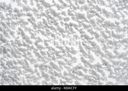 White snow texture. Snow-covered glass bottom view. Christmas and New Year background. Stock Photo