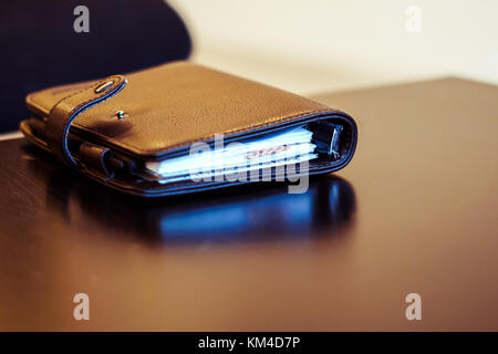 Closeup of notepad for agenda kept on table in empty corporate conference room before business meeting Stock Photo
