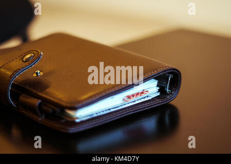 Closeup of notepad for agenda kept on table in empty corporate conference room before business meeting Stock Photo