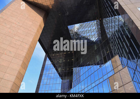 Looking up through a building made of glass and stone Stock Photo