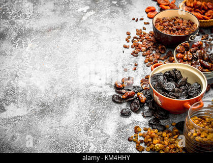 Various dried fruit in bowls. On rustic background . Stock Photo