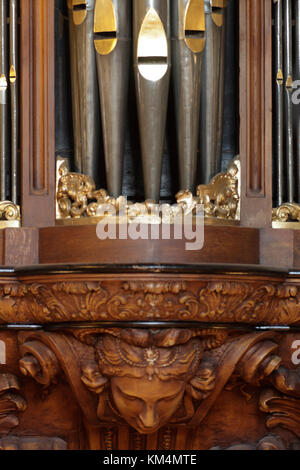 Detail of wood carving below organ with pipes above. De Rode Hoed Cultural Centre, Amsterdam, Netherlands. Architect: Unknown, 1630. Stock Photo