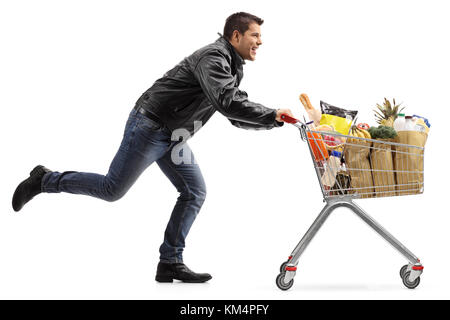 Full length profile shot of a biker running and pushing a shopping cart filled with groceries isolated on white background Stock Photo