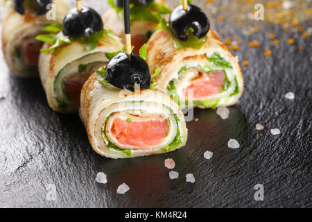 Pancake with salmon and salad leves roll Stock Photo