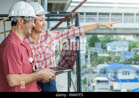 Happy professional construction engineers working with Corporate Colleagues Teamwork and technology laptop at the building site place, Industrial Conc Stock Photo
