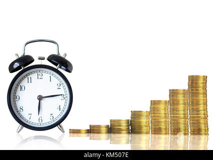 stacks of gold coins step with the vintage clock on white background, investment and financial concept Stock Photo