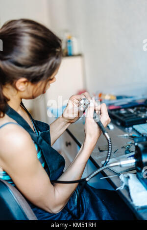 The girl is engaged in jewelry business Stock Photo - Alamy