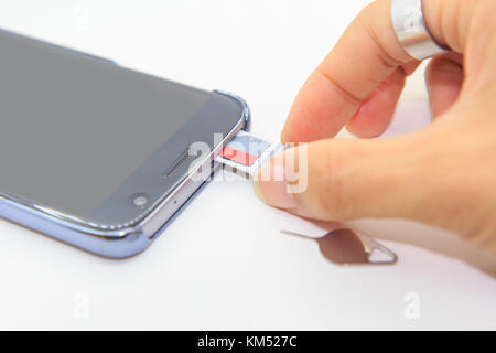 Remove memory card of smartphone Stock Photo