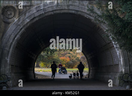 People pass through the tunnel, Cleft Ridge Span, built in 1871, near the landmark boathouse in Prospect Park, Brooklyn, NY. Stock Photo