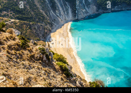 you see the beach of Myrtos on the island of Kefalonia in all its extension surrounded by mountains Stock Photo