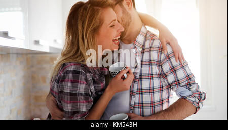 Romantic couple in love spending time together in kitchen Stock Photo