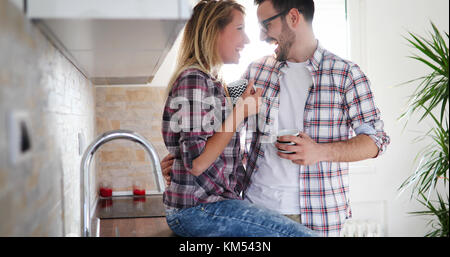 Romantic couple in love spending time together in kitchen Stock Photo