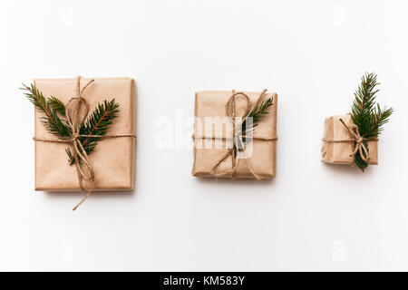 Three Vintage gift boxes with spruce branches on white isolated background, top view Stock Photo