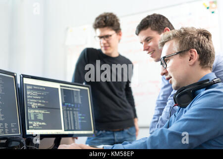 Startup business, software developer working on desktop computer. Stock Photo