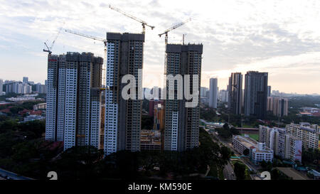 Buildings being constructed in Singapore on a partially cloudy day. Stock Photo