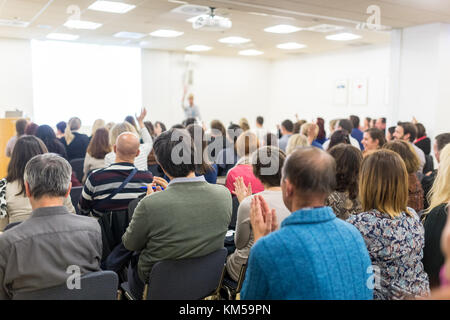 Woman giving interactive motivational speech at entrepreneurship workshop. Stock Photo