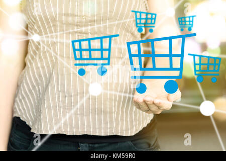 Woman holding illustration of shopping cart icons as commerce market concept. Stock Photo