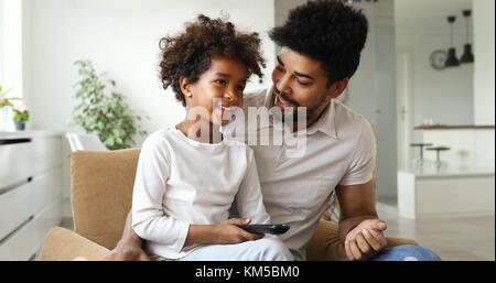 happy father and daughter and watching tv at home Stock Photo