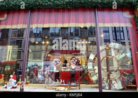 Knightsbridge. London, UK. 4th Dec, 2017. Shoppers and tourist passes by Harrods Christmas window display which is designed by Dolce & Gabbana. Its colourful display attracts thousands of visitors for the festival season. Credit: Dinendra Haria/Alamy Live News Stock Photo