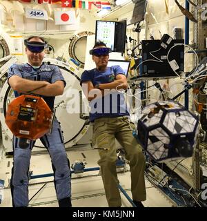International Space Station, Earth Orbit. 04th Dec, 2017. Expedition 53 Russian cosmonaut Sasha Misurkin, left, and American astronaut Joe Acaba, right, look through VR goggles during a test of the Zero Robotics student project aboard the International Space Station December 4, 2017 in Earth Orbit. Zero Robotics is a robotics programming competition for High School and Middle School students using SPHERES satellites inside the International Space Station. Credit: Planetpix/17�Թ����� Live News Stock Photo