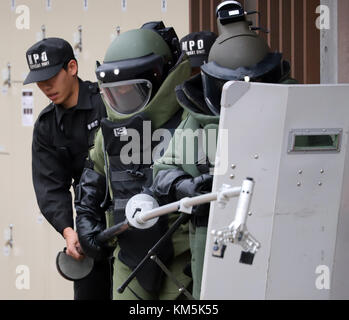 The Tokyo Metropolitan Police Department officers inspect the scene of ...