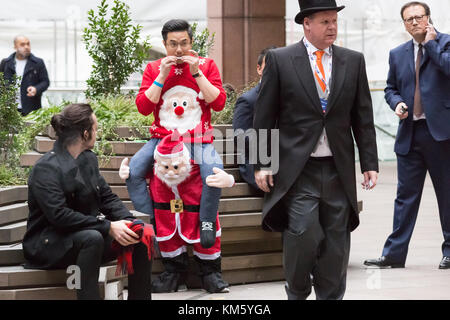 London, UK. 5th Dec, 2017. City traders arrive in fancy dress ready to attend the annual ICAP Charity Day. Credit: Guy Corbishley/Alamy Live News Stock Photo