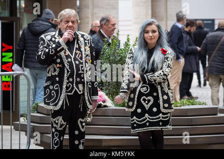 London, UK. 5th Dec, 2017. Pearly Kings and Queens, also known as Pearlies, take a break whilst attending the annual ICAP Charity Day. Credit: Guy Corbishley/Alamy Live News Stock Photo